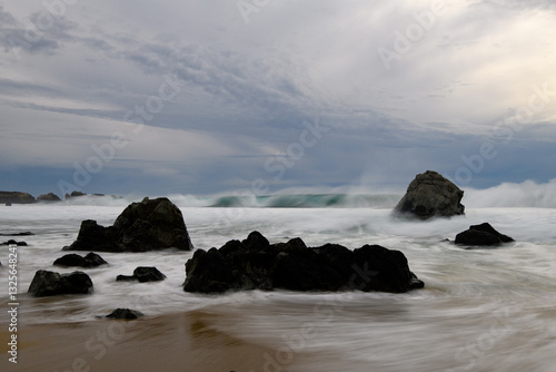 Принти на полотні Silhouetted rocks on rugged beach