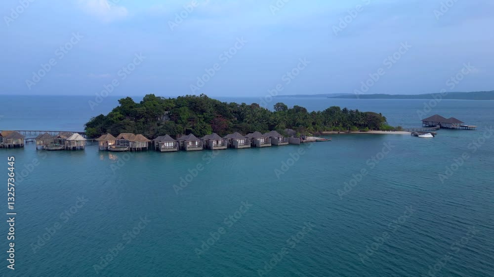 Song Saa Private Island, a luxury resort connecting two islands with a pier and overwater bungalows. Spectacular aerial view flight static tripod hovering drone Song Saa Private Island, a luxury resort connecting two islands with a pier and overwater bungalows. Spectacular aerial view flight static tripod hovering drone