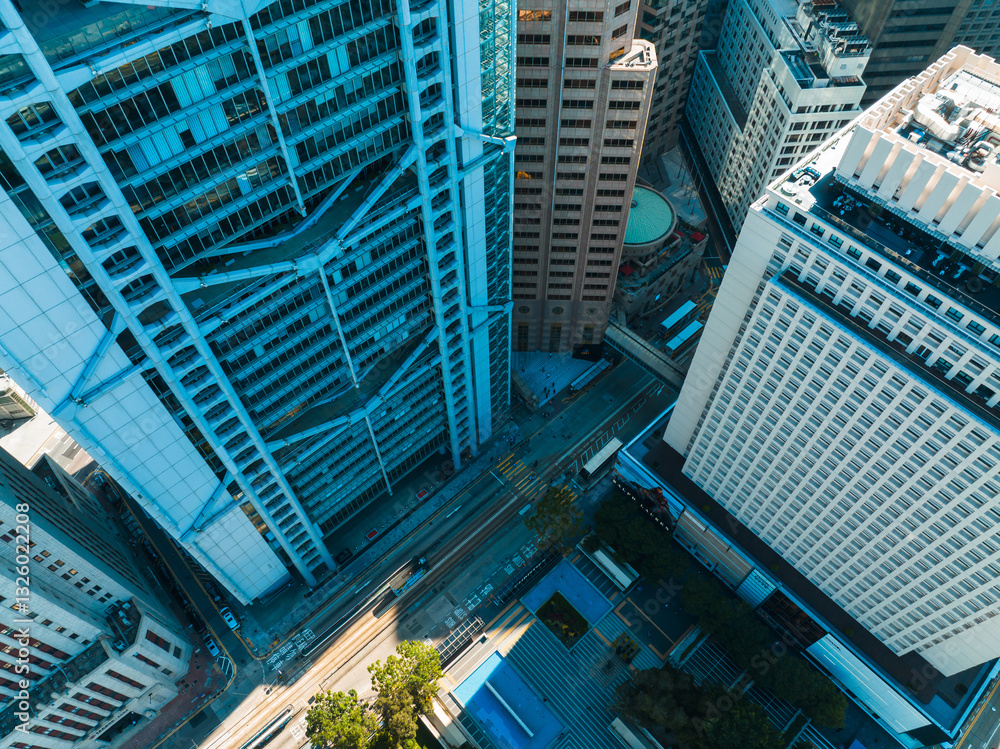 Aerial panorama of Hong Kong city showcases towering skyscrapers in a dense urban landscape. Roads and buildings dominate this high-angle view. Aerial panorama of Hong Kong city showcases towering skyscrapers in a dense urban landscape. Roads and buildings dominate this high-angle view.