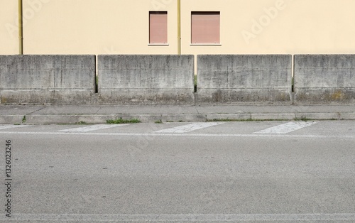 Wallpaper Mural Residential building concrete fence  divided in blocks at the roadside. Yellow plaster facade on behind, cement sidewalk and street in front. Background for copy space Torontodigital.ca