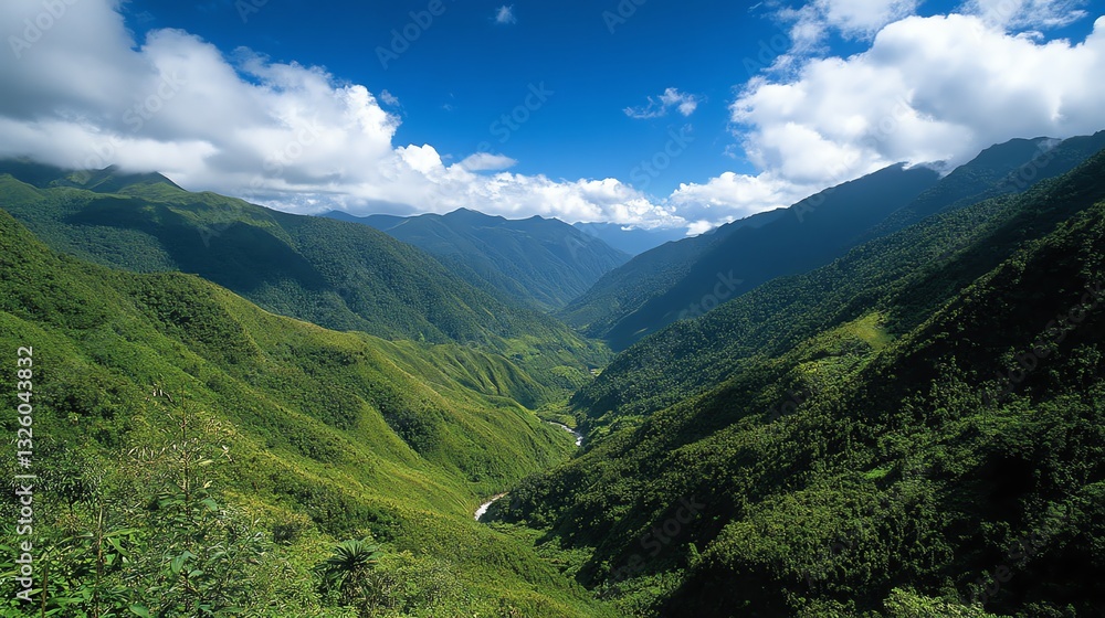 Naklejka premium Scenic Green Mountain Valley Landscape with Blue Sky and White Clouds