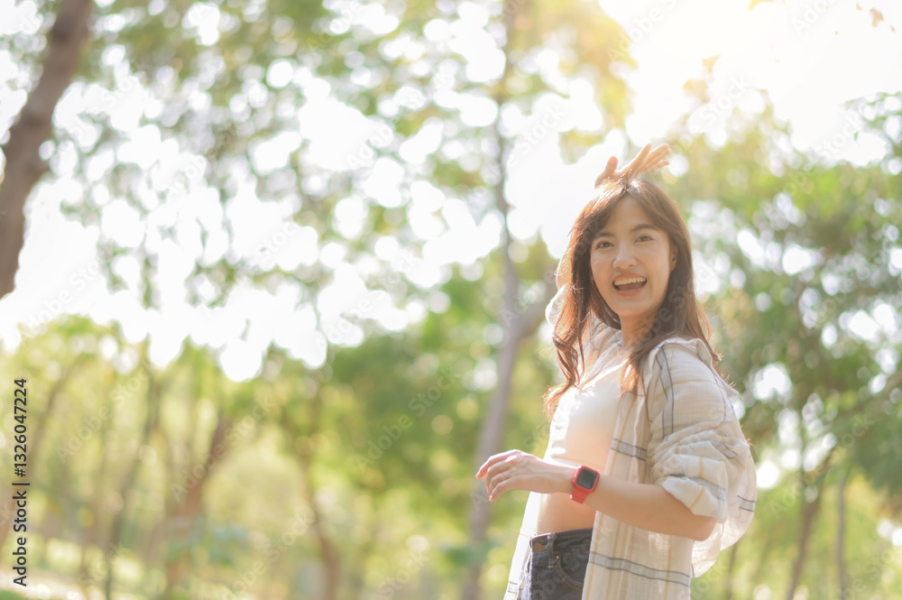 Asian woman enjoying summer outdoors, breathing fresh air with joyful smile in sunlit park surrounded by lush greenery Asian woman enjoying summer outdoors, breathing fresh air with joyful smile in sunlit park surrounded by lush greenery