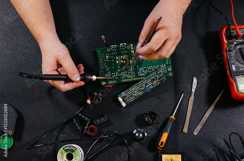 Electrician soldering a microchip