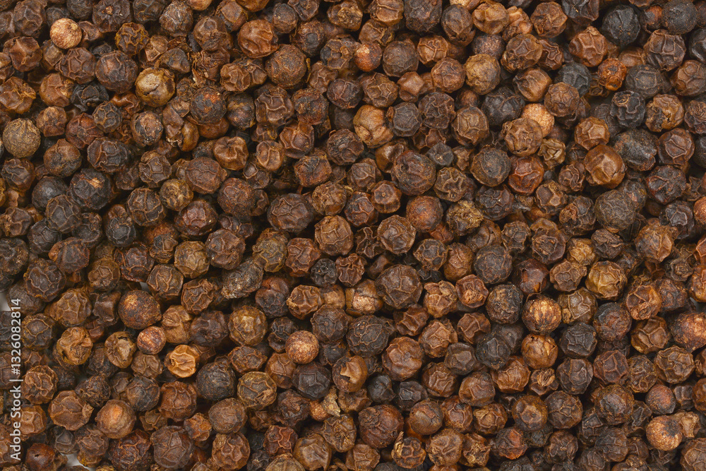A close-up, full-frame shot of dried black peppercorns, showcasing their texture and color A close-up, full-frame shot of dried black peppercorns, showcasing their texture and color