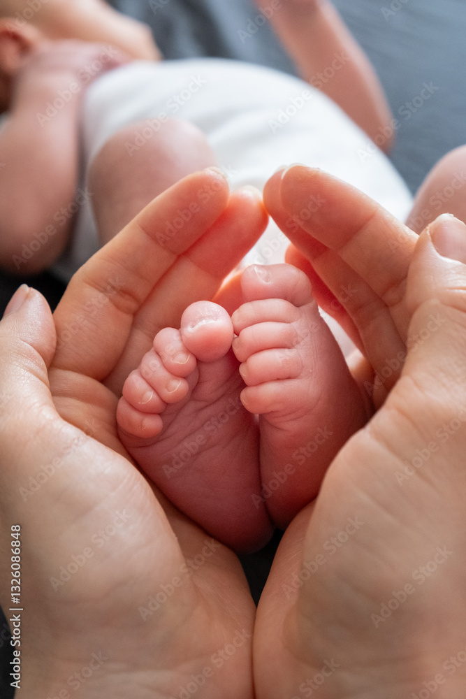 Tender Moment: Adult Hands Holding Newborn Baby Feet