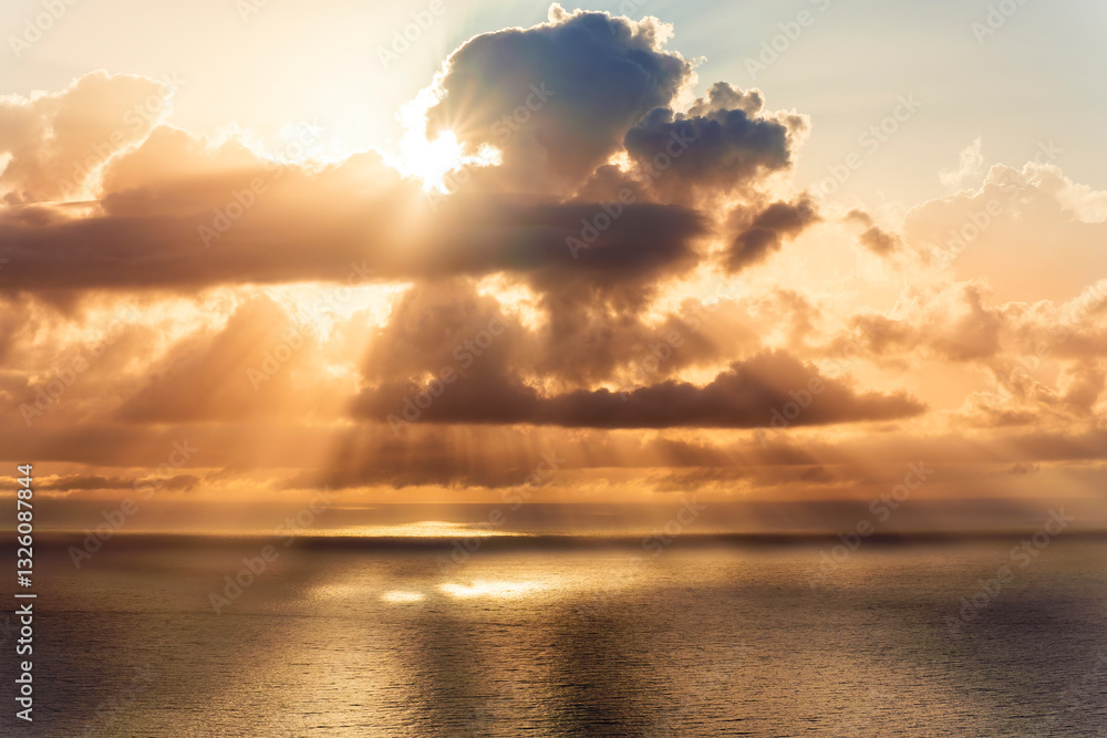Obraz premium cloud in a form of flying sauser with light and shadows in amazing sunrise or sunset sky above water in beautisul seascape