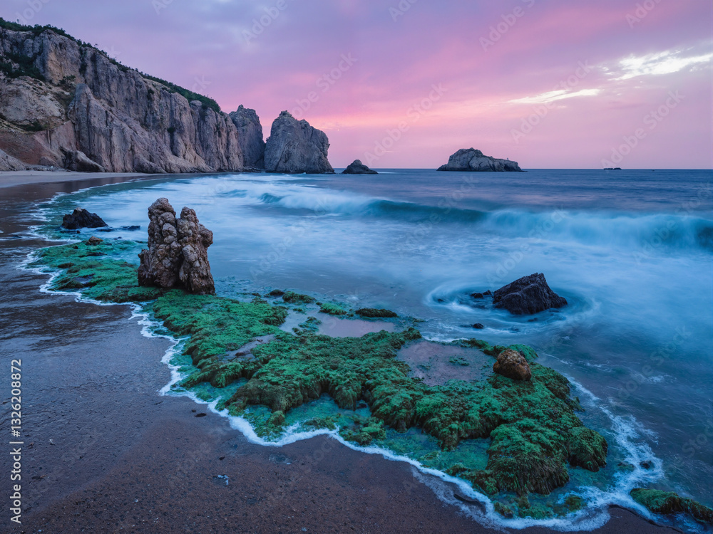 seascape at sunset with dramatic rock
