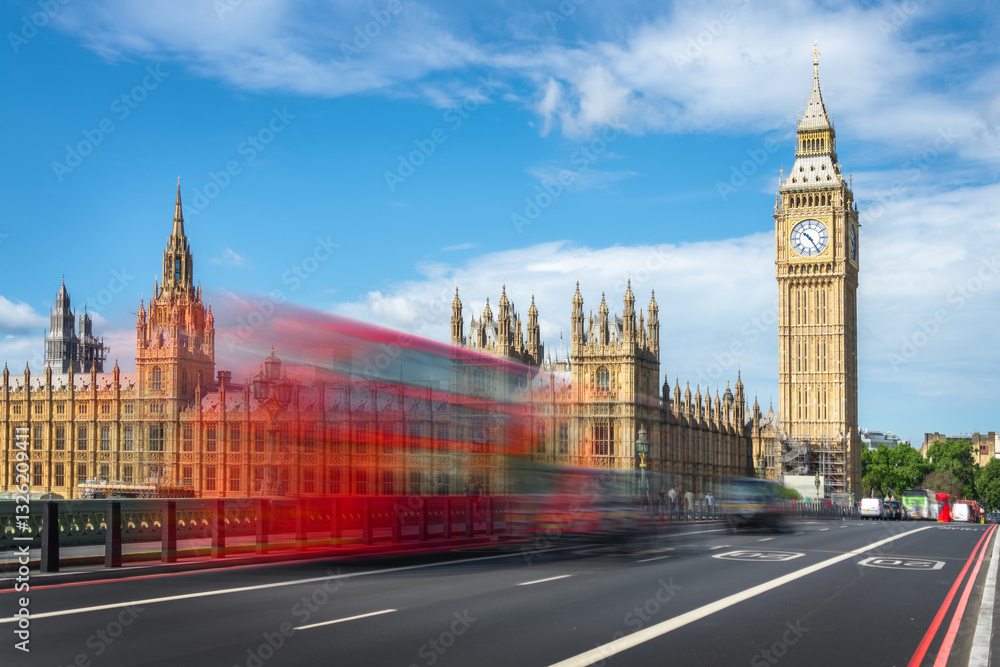 Red double decker bus with motion blur on Westminster bridge, Big Ben in the background, London cityscape, UK travel