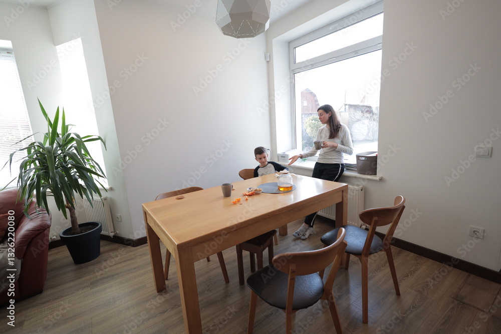 Mother and a boy spending time together playing indoors Mother and a boy spending time together playing indoors