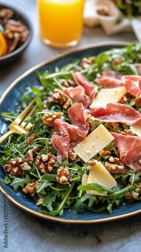 Fresh Arugula Salad Topped With Prosciutto, Walnuts, and Cheese on a Table Wi...