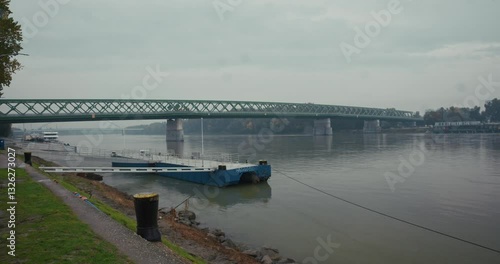 Wallpaper Mural Steel truss bridge spanning the Danube River in Bratislava under cloudy skies Torontodigital.ca