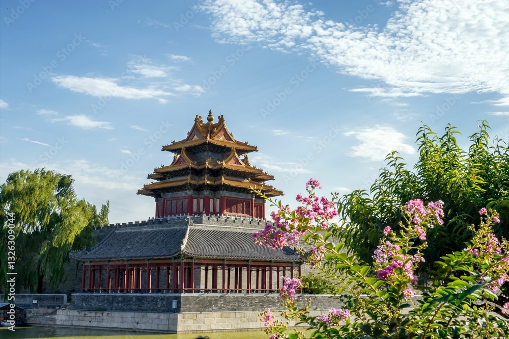 Traditional Chinese pavilion with flowers and blue sky.