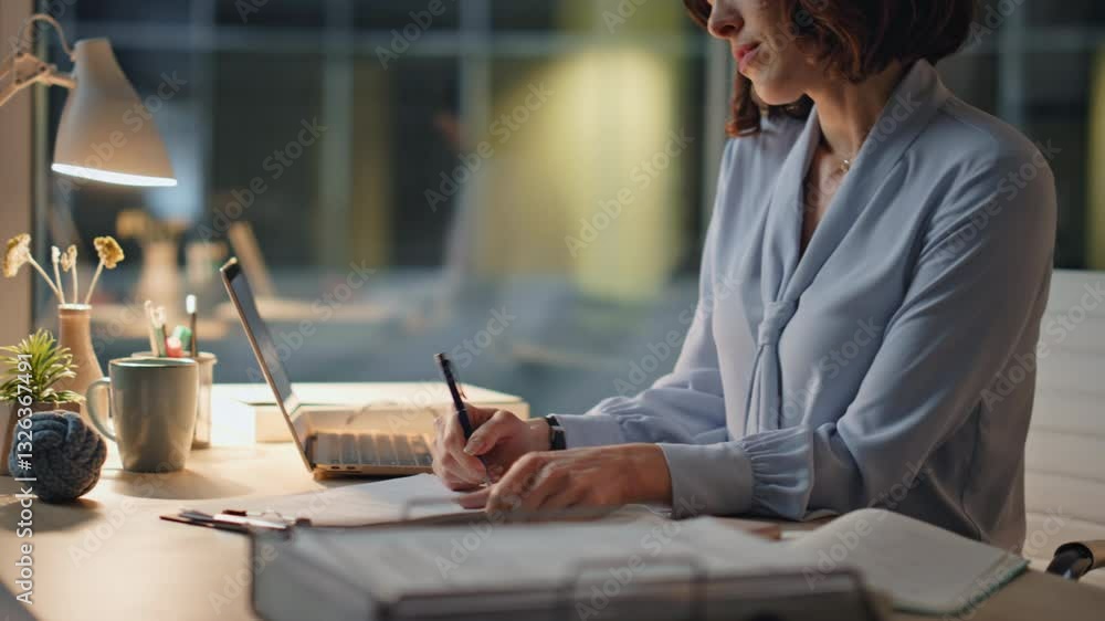 Hardworking employee writing documents sitting evening office closeup. Late work Hardworking employee writing documents sitting evening office closeup. Late work