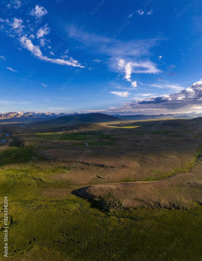 Aerial view of breathtaking Deosai Plains with majestic mountains and serene valleys under a blue sky with clouds, Gilgit Baltistan, Pakistan. Aerial view of breathtaking Deosai Plains with majestic mountains and serene valleys under a blue sky with clouds, Gilgit Baltistan, Pakistan.