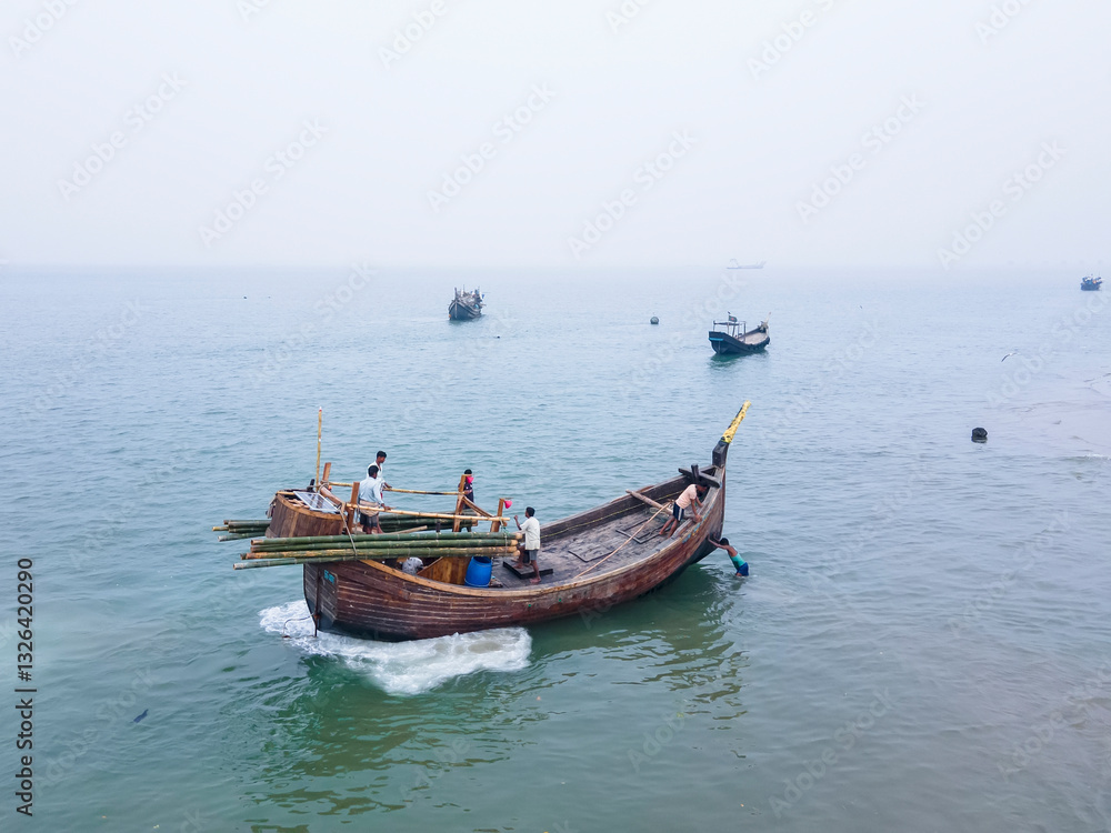 Cox'S Bazar, Bangladesh - 07 February 2024: Aerial view of colorful fishing boats along the coastline with golden sands and turquoise waters, Cox's Bazar, Cox's Bazar, Bangladesh. Cox'S Bazar, Bangladesh - 07 February 2024: Aerial view of colorful fishing boats along the coastline with golden sands and turquoise waters, Cox's Bazar, Cox's Bazar, Bangladesh.