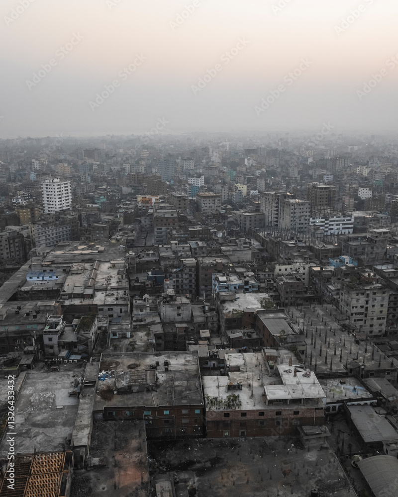 Aerial view of a crowded urban skyline with high-rise buildings at dusk, Sadar Ghat, Keraniganj, Dhaka, Bangladesh. Aerial view of a crowded urban skyline with high-rise buildings at dusk, Sadar Ghat, Keraniganj, Dhaka, Bangladesh.