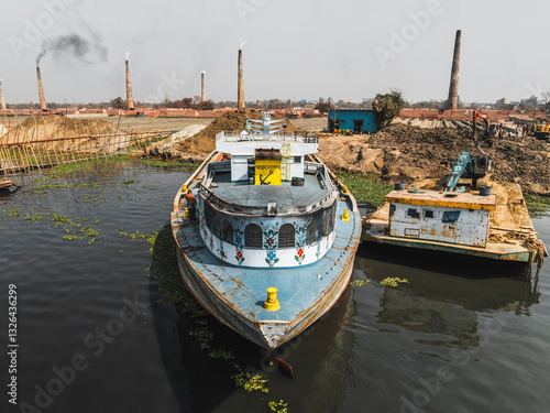 Aerial view of Dhaleshwari River with traditional boats and a brick factory, Baktaballi, Narayanganj, Dhaka, Bangladesh. photo