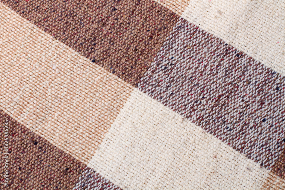 Fototapeta premium Brown and white checkered fabric texture in a close up view