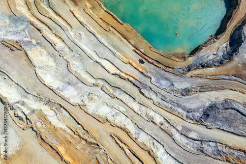Aerial view of the industrial iron ore mine with exposed rock formations and scarred terrain, Erzberg, Styria, Austria.