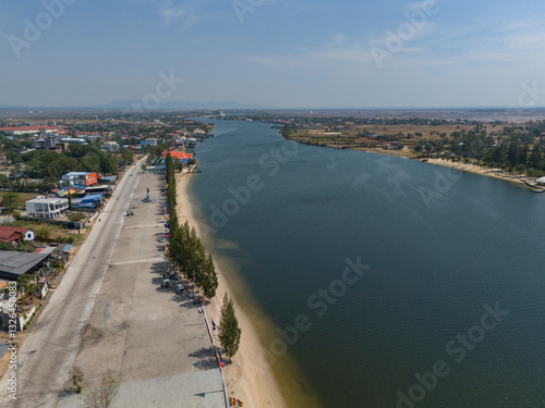 Wallpaper Mural Aerial view of tranquil riverside landscape with a clear sky and scenic town, Tuek Chhou District, Kampong Kandal, Cambodia. Torontodigital.ca