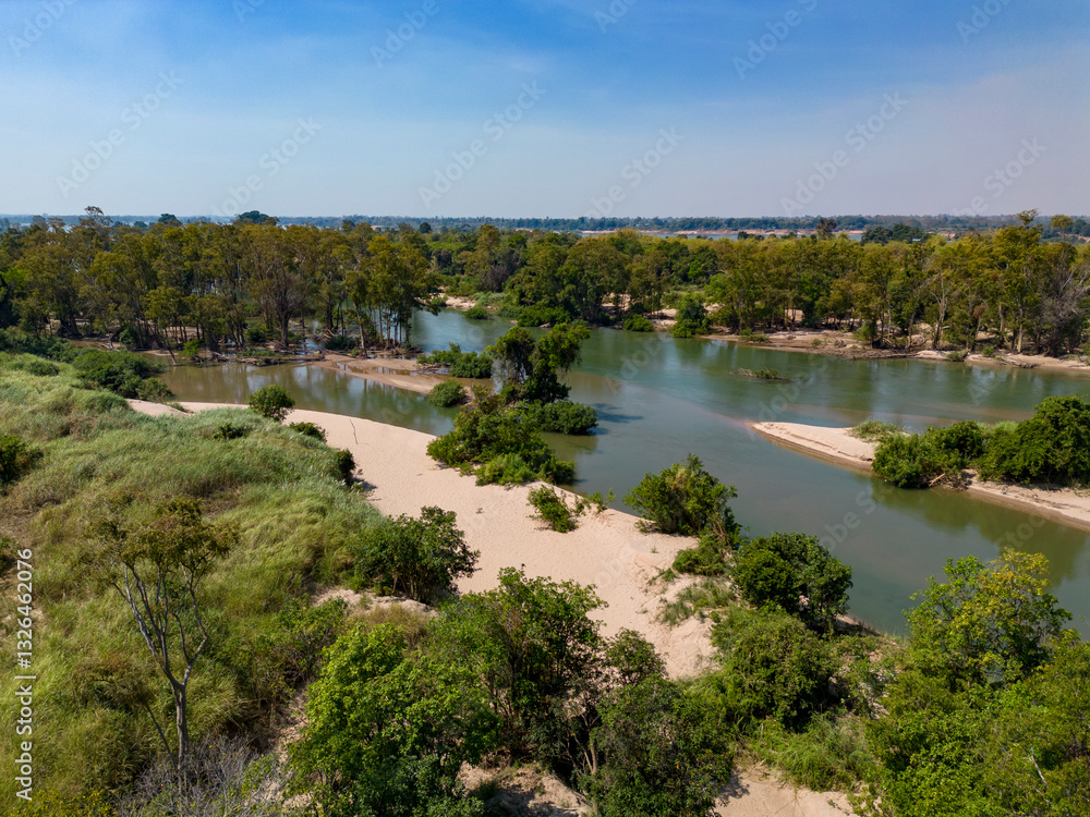 Aerial view of Koh Han Island surrounded by a tranquil river and lush greenery, Sameakki, Stung Treng Municipality, Cambodia. Aerial view of Koh Han Island surrounded by a tranquil river and lush greenery, Sameakki, Stung Treng Municipality, Cambodia.