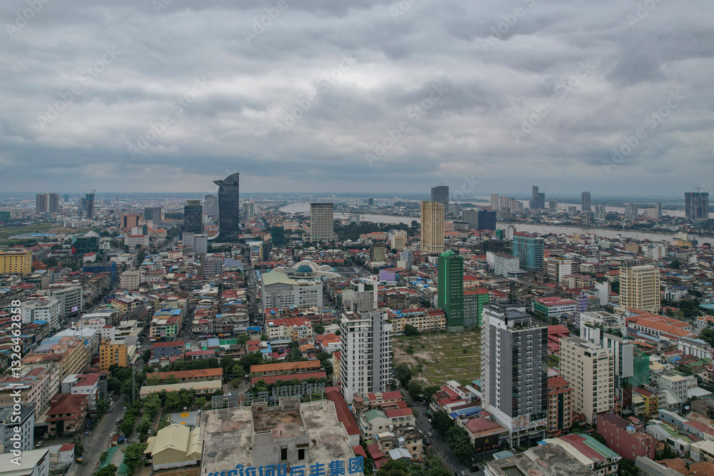 Aerial view of modern urban skyline with high-rise buildings and a river, Daun Penh District, Phnom Penh, Cambodia. Aerial view of modern urban skyline with high-rise buildings and a river, Daun Penh District, Phnom Penh, Cambodia.