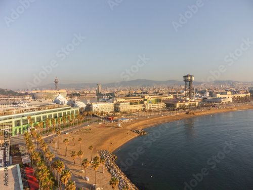 Aerial view of beautiful coastal cityscape featuring beach, sea, palm trees, and modern buildings, Ciutat Vella, Barcelona, Spain. photo