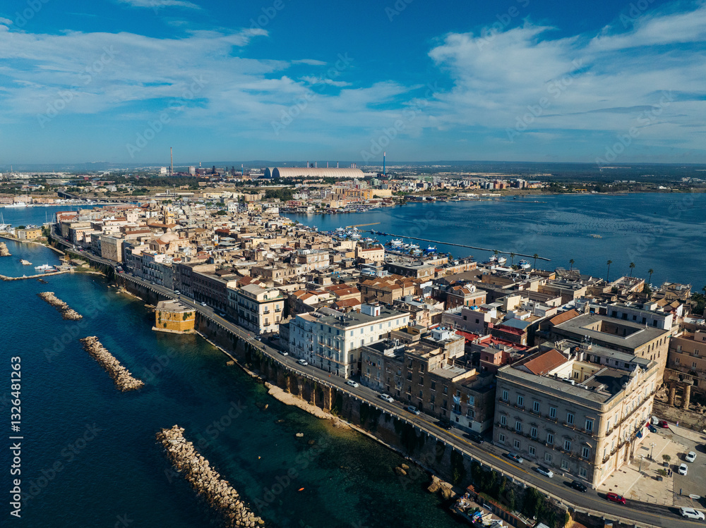 Aerial view of vibrant coastal cityscape with historic architecture and scenic harbor, Taranto, Taranto, Italy. Aerial view of vibrant coastal cityscape with historic architecture and scenic harbor, Taranto, Taranto, Italy.