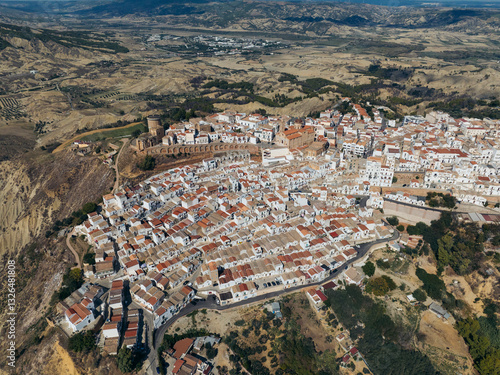 Aerial view of picturesque historic town with traditional clay roofs and winding streets on a hillside, Pisticci, Matera, Italy.