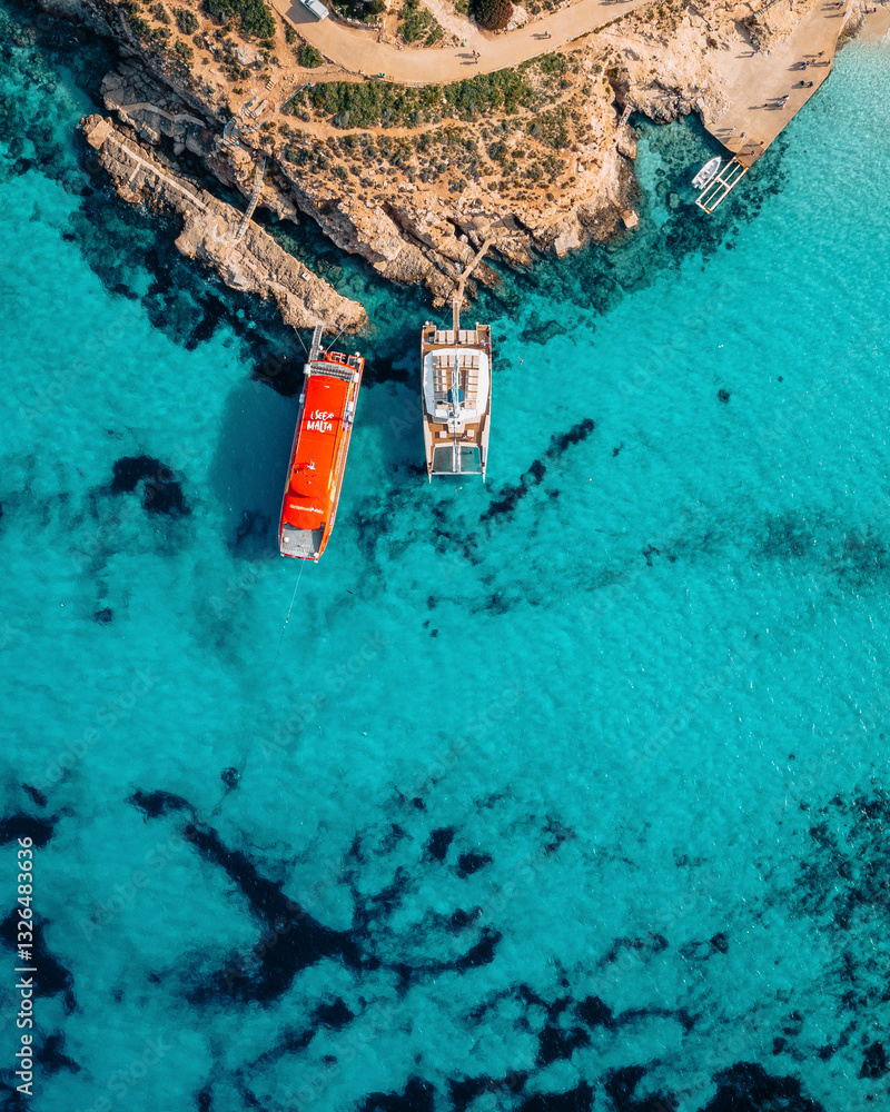 Aerial view of blue lagoon with transparent water and anchored boats, Ghajnsielem, Malta. Aerial view of blue lagoon with transparent water and anchored boats, Ghajnsielem, Malta.