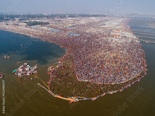 Aerial View of people gathering for Prayag Kumbh Mela along the Yamuna River, a holy festival for devotes happening in Triveni Sangam in Prayagraj, Uttar Pradesh, India.