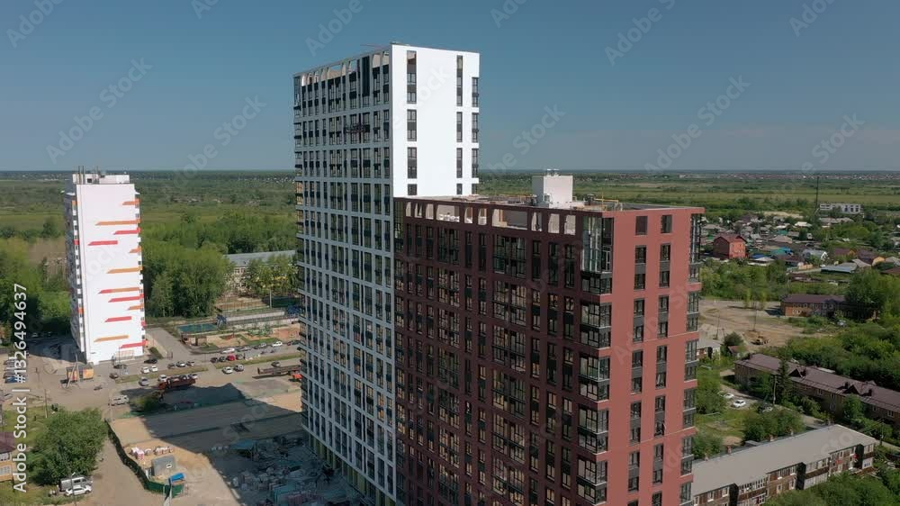 Modern residential high-rise buildings with large reflective windows in an urban environment Modern residential high-rise buildings with large reflective windows in an urban environment