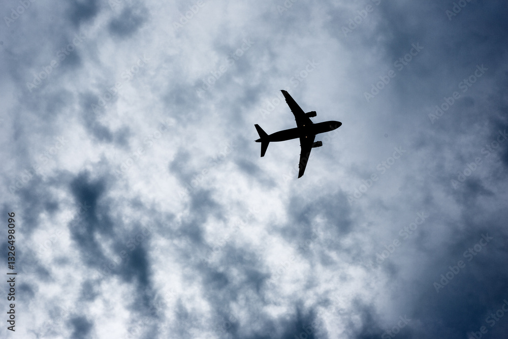 Airplane Silhouette Against Cloudy Sky Airplane Silhouette Against Cloudy Sky