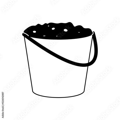 Bucket filled with sand or soil resting on a plain background