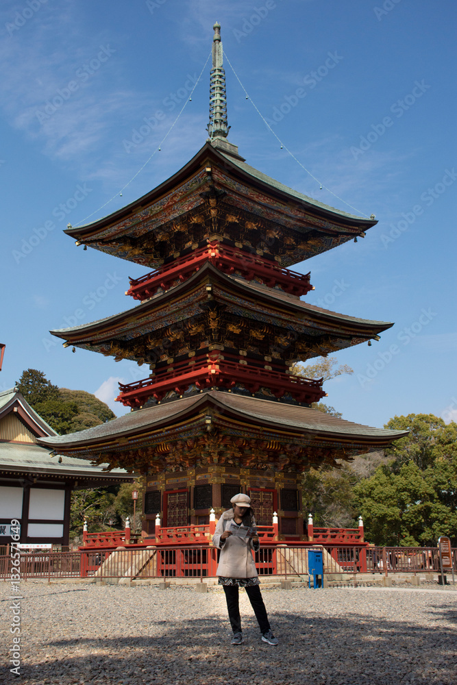 Traveler thai women looking map and reading guide book about Daitou or Great Peace Pagoda of Naritasan Shinshoji Temple at Chiba Prefecture in Tokyo, Japan Traveler thai women looking map and reading guide book about Daitou or Great Peace Pagoda of Naritasan Shinshoji Temple at Chiba Prefecture in Tokyo, Japan