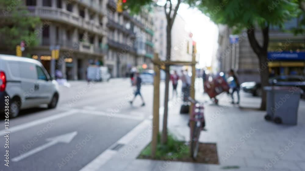 Blurry city street scene in barcelona, spain, showcasing defocused pedestrians, traffic, and urban life under soft sunlight. Blurry city street scene in barcelona, spain, showcasing defocused pedestrians, traffic, and urban life under soft sunlight.