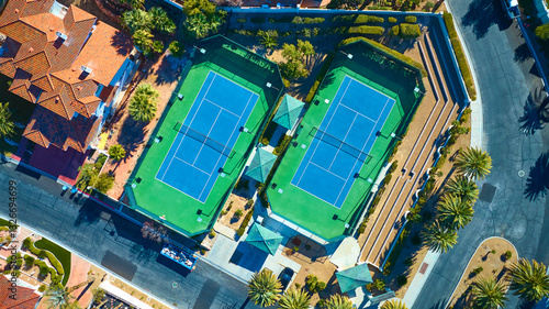 Aerial Top Down of Luxury Tennis Courts in Upscale Suburban Neighborhood