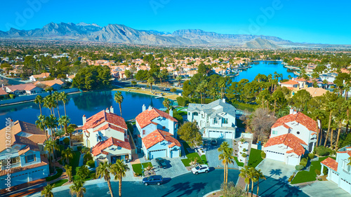 Photography Aerial of Desert Suburb with Lake and Mountains