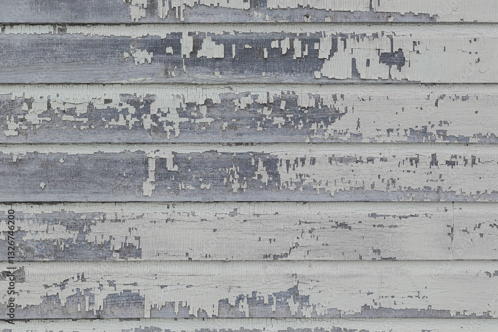 Fototapeta premium Peeling white paint on an old wooden wall.