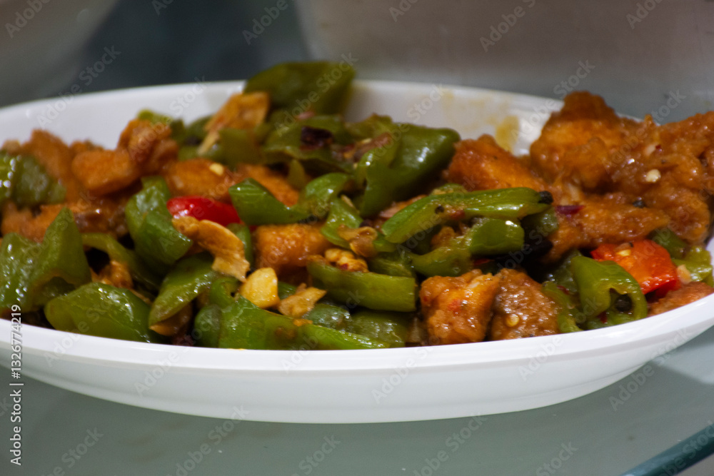 Traditional chinese food gourmet meal or local cuisine cultural tribe Stir-fried crispy fish batter with Bell pepper and chili paste serve customers people taste eat drink at restaurant in Hunan China Traditional chinese food gourmet meal or local cuisine cultural tribe Stir-fried crispy fish batter with Bell pepper and chili paste serve customers people taste eat drink at restaurant in Hunan China