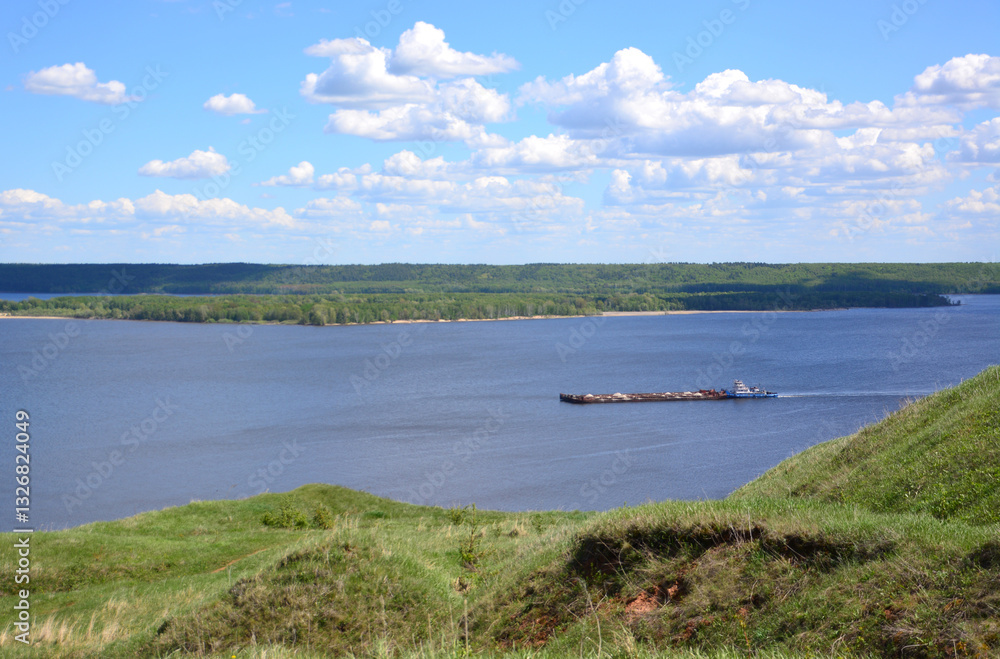 River landscape with frieght boat in a sunny summer day River landscape with frieght boat in a sunny summer day