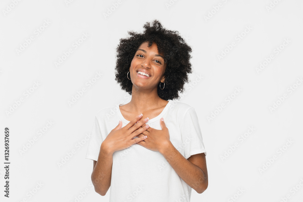 Happy impressed afro-american woman girl female student say thank you, holding hands on heart grateful, express gratitude, touched by compliment keeps hands on chest standing against white background.