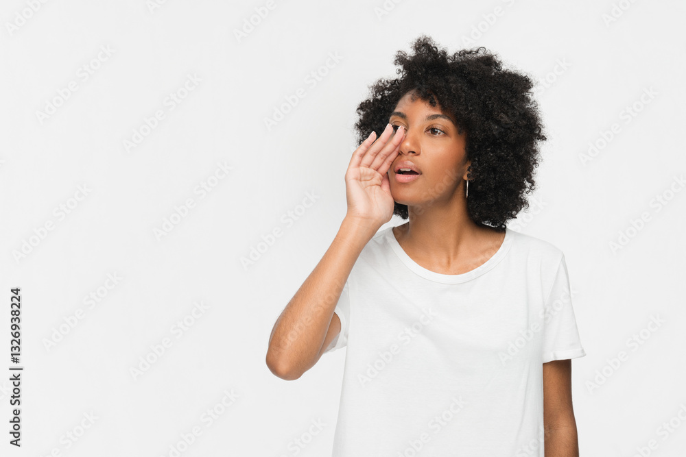 Funny young African American woman girl in white shirt posing screaming shouting yelling bawls isolated on white color wall background studio portrait. People sincere emotions lifestyle concept. Funny young African American woman girl in white shirt posing screaming shouting yelling bawls isolated on white color wall background studio portrait. People sincere emotions lifestyle concept.