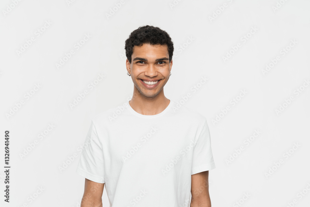 Portrait of handsome dark skinned African man smiles pleasantly being in good mood poses against white background wears casual outfit . People emotions and happy feelings concept. Studio shot Portrait of handsome dark skinned African man smiles pleasantly being in good mood poses against white background wears casual outfit . People emotions and happy feelings concept. Studio shot