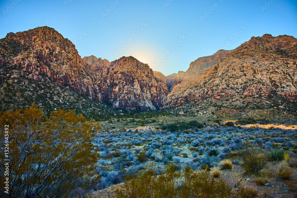 Obraz premium Rugged Red Rock Mountains at Sunrise with Desert Vegetation in Foreground