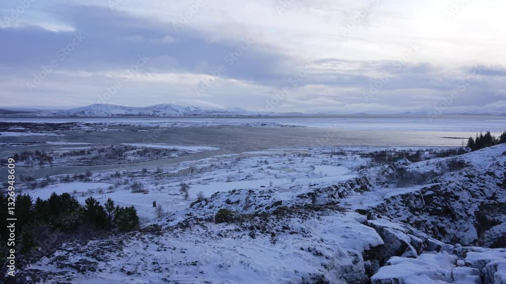 View of the river and snow covered landscape in Thingvellir National Park in winter, UNESCO, Golden Circle, Western Region, Iceland View of the river and snow covered landscape in Thingvellir National Park in winter, UNESCO, Golden Circle, Western Region, Iceland