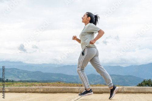 Lifestyle: Athletic Latina woman running on the road