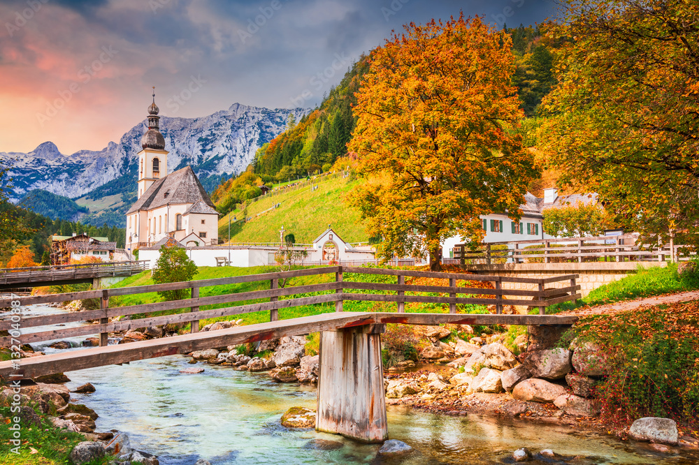 Ramsau am Berchtesgaden, Germany. Autum colored landscape of Saint Sebastian Church and River Ramsauer Ache, Bayern.