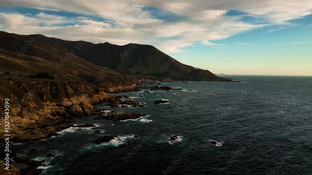 Aerial view of pebble beach coastline with waves and clouds, Carmel, California, United States. Aerial view of pebble beach coastline with waves and clouds, Carmel, California, United States.