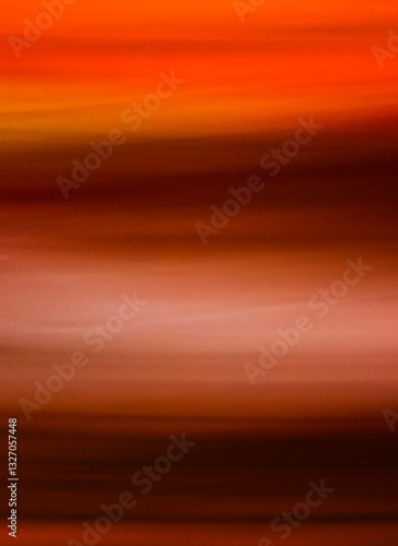 A breathtaking display of warm hues forms a smooth gradient across the canvas, with orange and brown swirling together elegantly